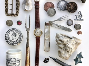 Flatlay of smaller streamlarking finds including restored Garrard watch and folding silver fruit set © Jane Eastman