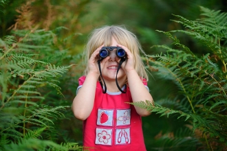 Girl using binoculars © David Tipling - 2020VISION