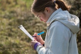 Teenager surveying for species at Milton Locks nature reserve