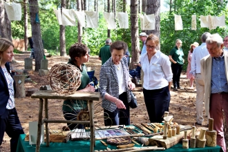 Princess Royal looking at woodland crafts