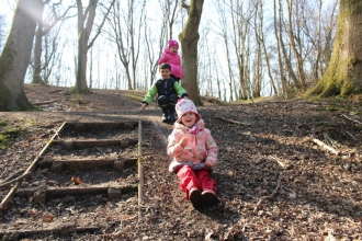Children sliding down mud slope