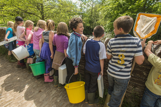 Children preparing to take a river kick sample © Ross Hoddinott/2020VISION