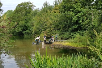 Volunteers clearing invasive plants at Laverstoke Pond in August 2020 © HIWWT