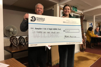 Lauren HIWWT fundraiser and member of Fareham Bowls Club holding check that reads £640