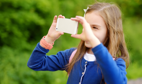 Girl taking photo with smartphone © MNStudio