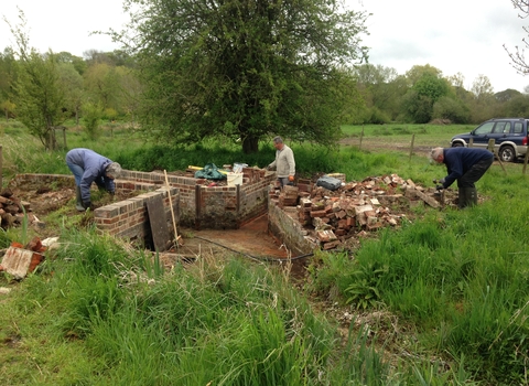 Volunteers restore a water meadow heritage structure at Bere Mill © HIWWT