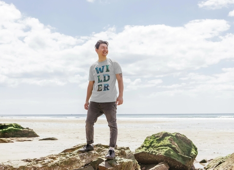 Man wearing wilder t-shirt on beach