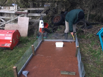 Volunteer building a tern raft at Farlington Marshes