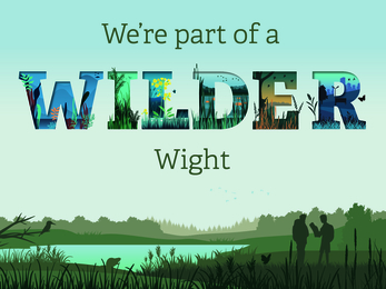 Sign saying "we're part of a Wilder Wight" where "WILDER" lettering is stylised.