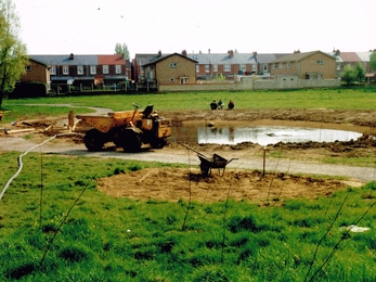 Diggers parked outside residential street preparing to landscape