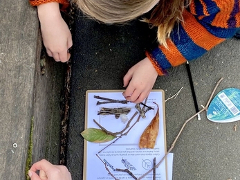 Community members do an activity from the Nature (Curious) Explorer Backpack © James Aldridge