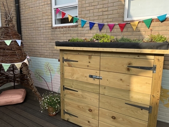 A sensory garden incorporating a wicker teepee seat and planters