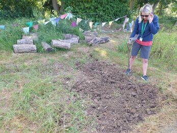 Louise Moreton Environmental Learning Assistant preparing flower beds