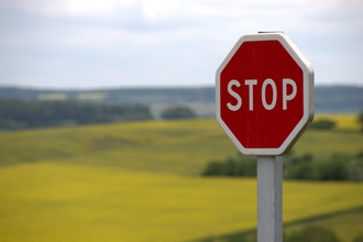 Stop Sign with green landscapes