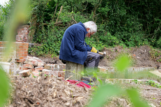Colin Nichols, Chalk Stream Champion, restoring brickwork at Bere Mill © HIWWT small
