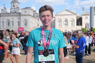 Ben after completing the marathon with medal around his neck 