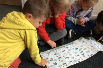 Children looking at ID guide