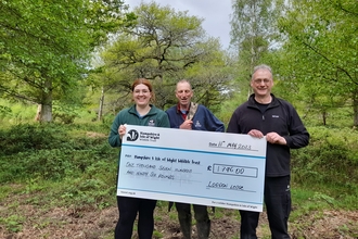Colin, worshipful master of Loddon Lodge Freemasons with Trust staff holding presentation cheque in Pamber Forest