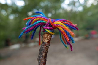 Stick figure with rainbow wool hair