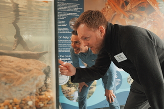 Principal Ecologist Dr Ben Rushbrook & Ecologist Tom Selby looking into white-clawed crayfish tank