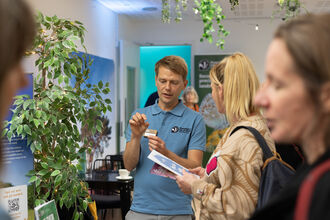 Trust staff talking to public at indoor event