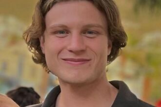 Olly Cummins smiling at the camera 