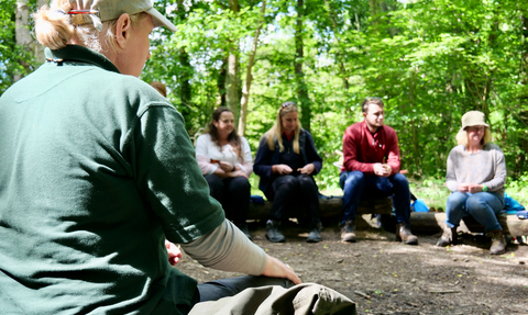 Hampshire & isle of wight wildlife trust staff delivering forest school training to a group of teachers and leaders