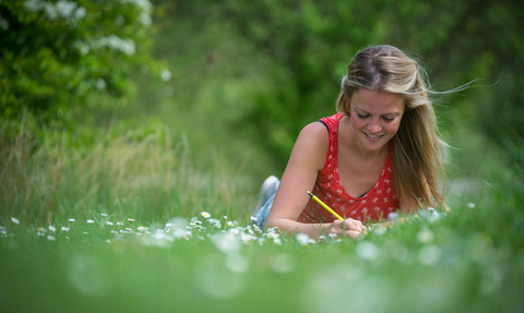 Woman writing in nature © Matthew Roberts