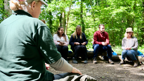 Hampshire & isle of wight wildlife trust staff delivering forest school training to a group of teachers and leaders