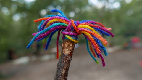 Stick figure with rainbow wool hair