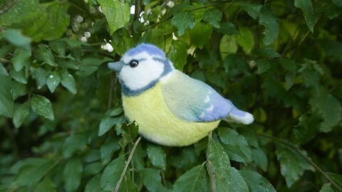 Blue Tit bird toy sitting in a tree
