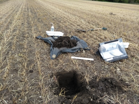 A soil pit dug in an agricultural field