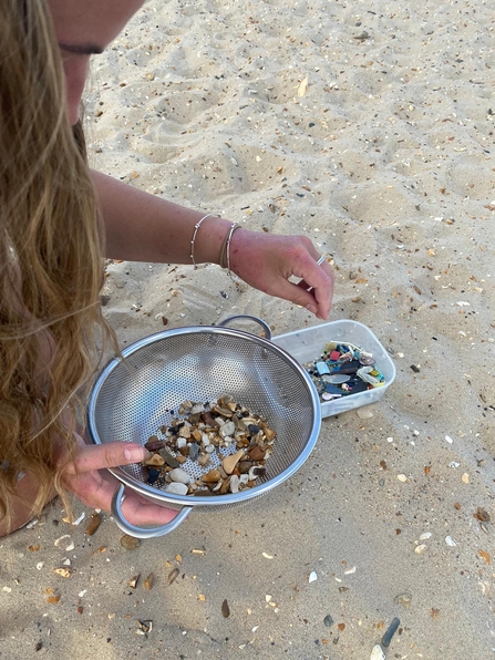 Marine Champion Natalie Harris sieving microplastic