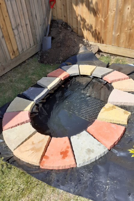 Phase 1 of building pond. Paving stones and water added.