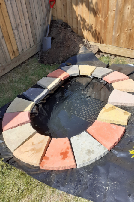 Phase 1 of building pond. Paving stones and water added. 