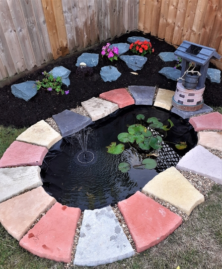 Rockery surrounding small garden pond