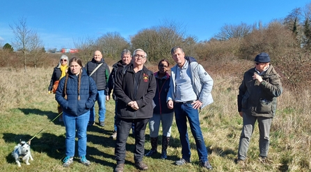A group photo of people in winter clothes on a sunny day 
