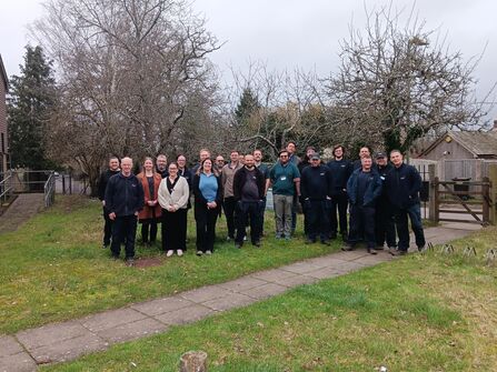 A large group of people standing for a photo in an outdoor space