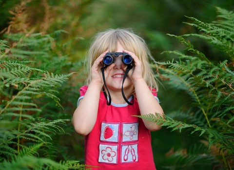 Girl using binoculars © David Tipling - 2020VISION