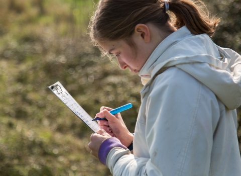 Teenager surveying for species at Milton Locks nature reserve