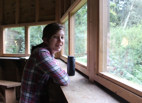 Teenager in Woodland Hide at Blashford Lakes nature reserve