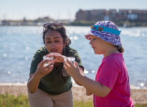 Lianne de Mello showing Alice Barnes a grasshopper at Milton Locks Heritage Art Day © Paul Gonella