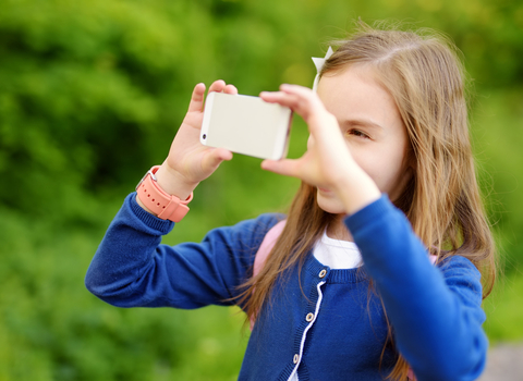 Girl taking photo with smartphone © MNStudio