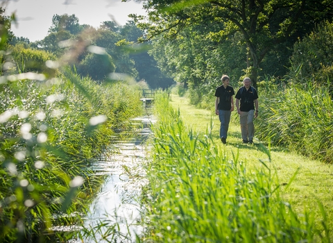 People walking by a river © Matthew Roberts