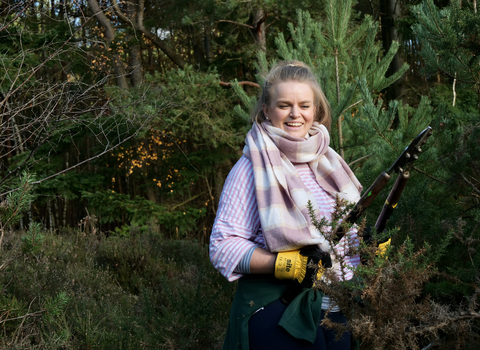 staff member cutting trees back