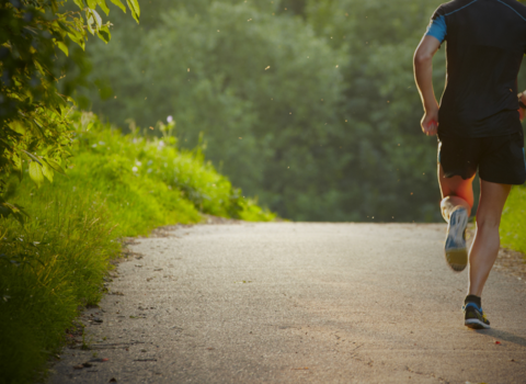person running in outdoor green space 