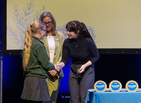 Wilder Awards 2025 Young Changemaker on stage being presented award by Megan Mccubbin 