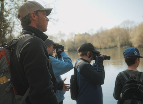 3 teenagers and 1 adult looking out onto a lake